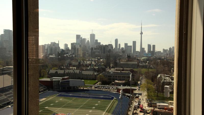 The view from a window in the OISE building looks over Varsity Stadium and downtown Toronto.