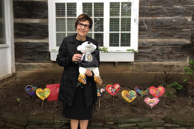 Cindy Blackstock in front of a heart garden planted to honour the children who died in residential schools: “I am holding Spirit Bear – the teddy bear who witnessed all the hearings of the Canadian Human Rights Tribunal on First Nations Child Welfare."
