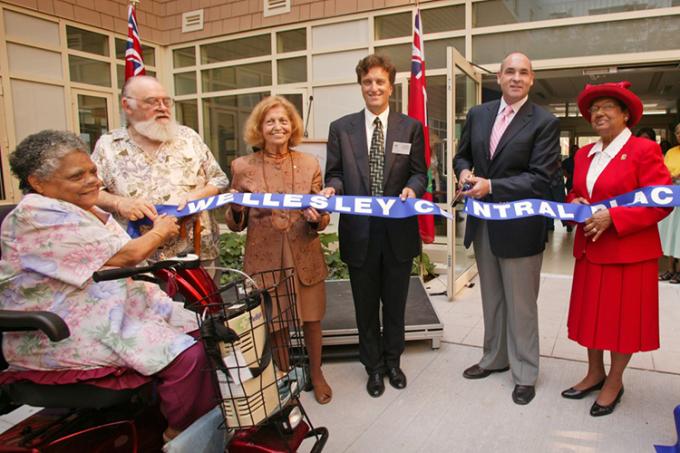 Peter Rekai (centre) cuts the ribbon with current residents and board member at the opening of Wellesley Central Place in 2005 (photo courtesy of the Rekai Centres)