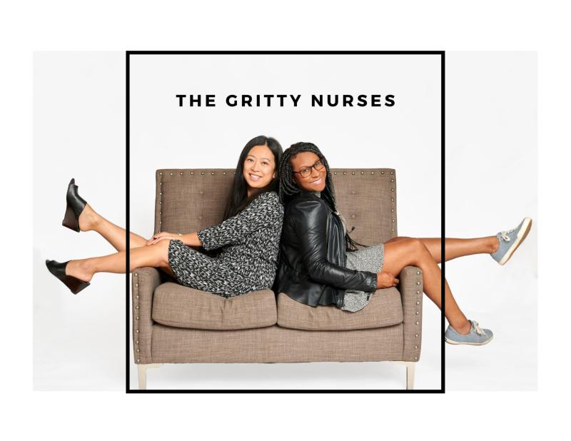 Two women back to back on a sofa