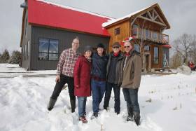 The Tomory family in front of their red-roofed barn at Pefferlaw Creek Farms