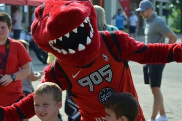 Raptors 905 mascot posing with kids