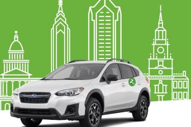 Zipcar against illustration of city skyline