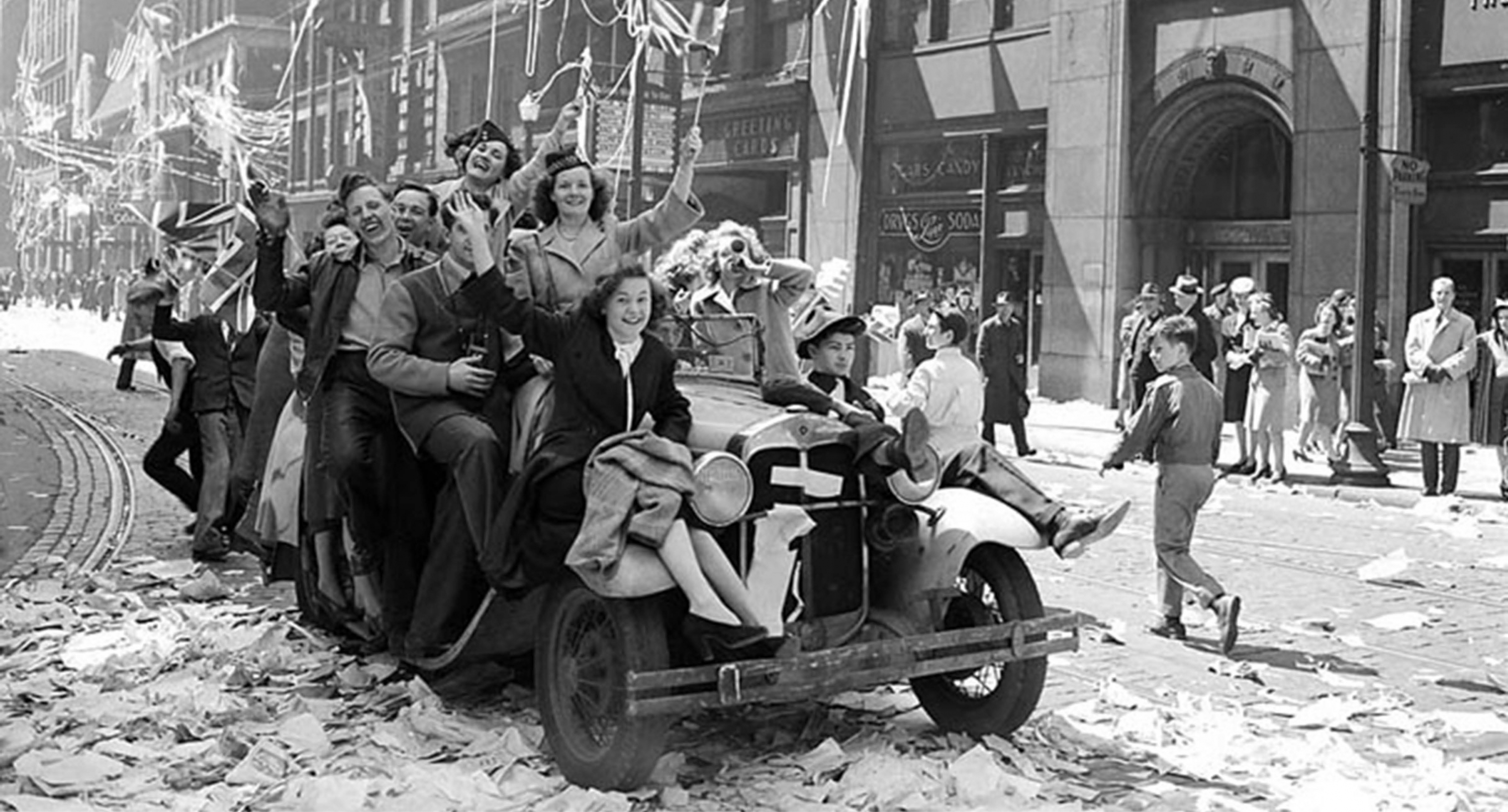 Black and white photo of a group of Canadians riding a car together at the time of the second world war