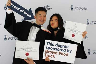 Photo of two alumni posing together in photo booth.