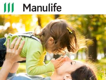 Mother playing with young daughter in a park.