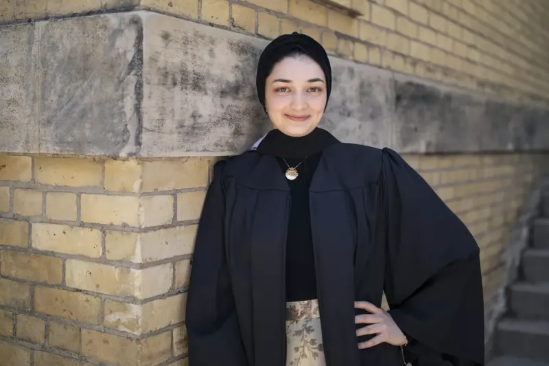 A portrait of Mariam Ismail wearing a black graduation gown