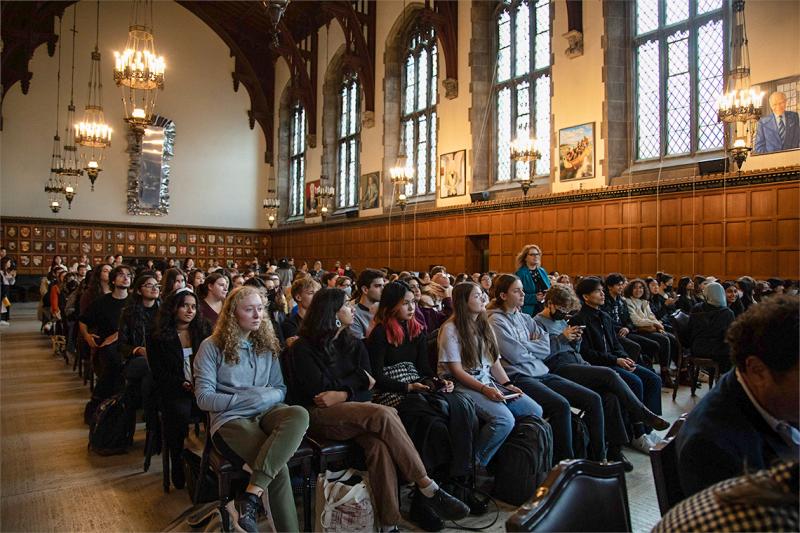 Every seat is taken in an audience of students filling Hart House Great Hall.