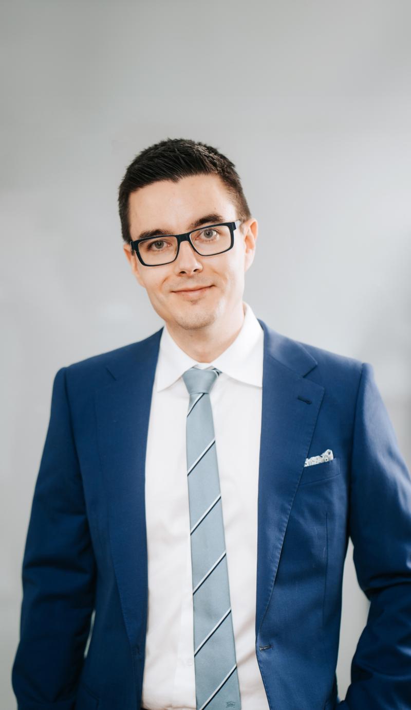 Portrait of Alik wearing a navy blue suit