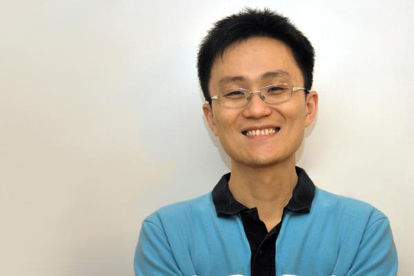 Photo of Allen Lu smiling in front of white wall