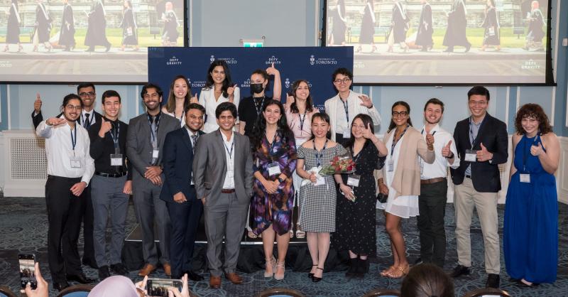 The graduating Pearson Scholars smile and give the thumbs up as they pose for a photo.