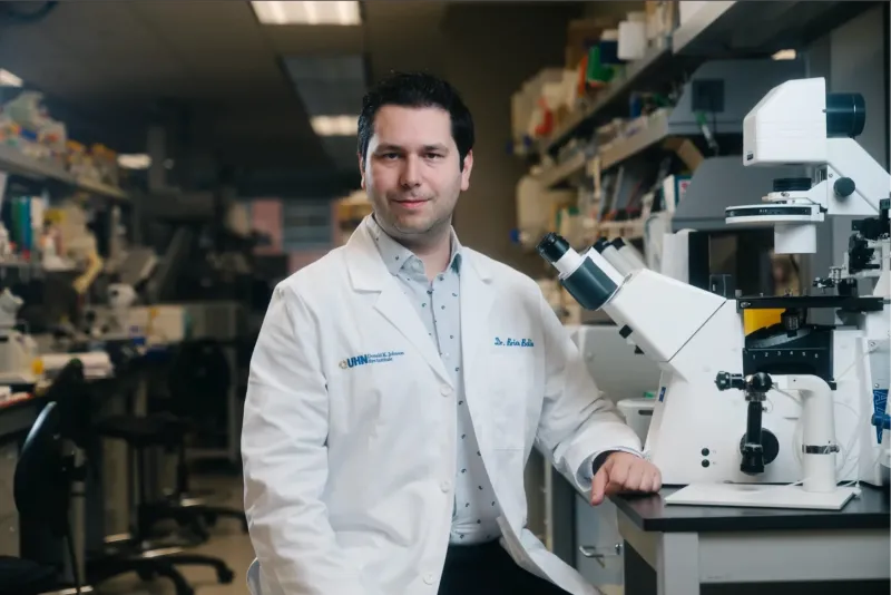 Brian in a lab wearing a white coat