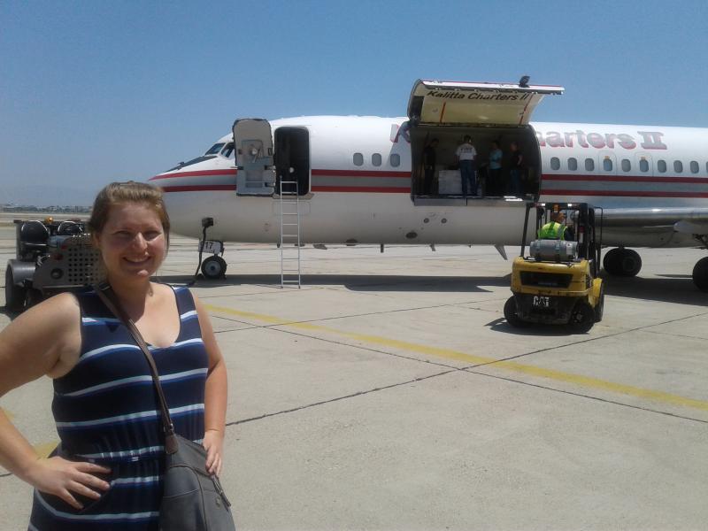 Camilla Urbaniak standing in front of the NASA plane that holds her research samples.