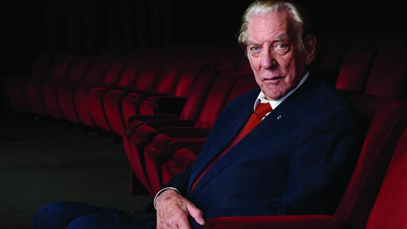 Portrait of Donald Sutherland sitting in a theatre