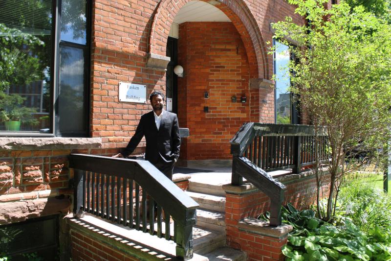 Prasanna Balasundaram at the U of T community legal clinic on Spadina Avenue, an old brick building in a garden.