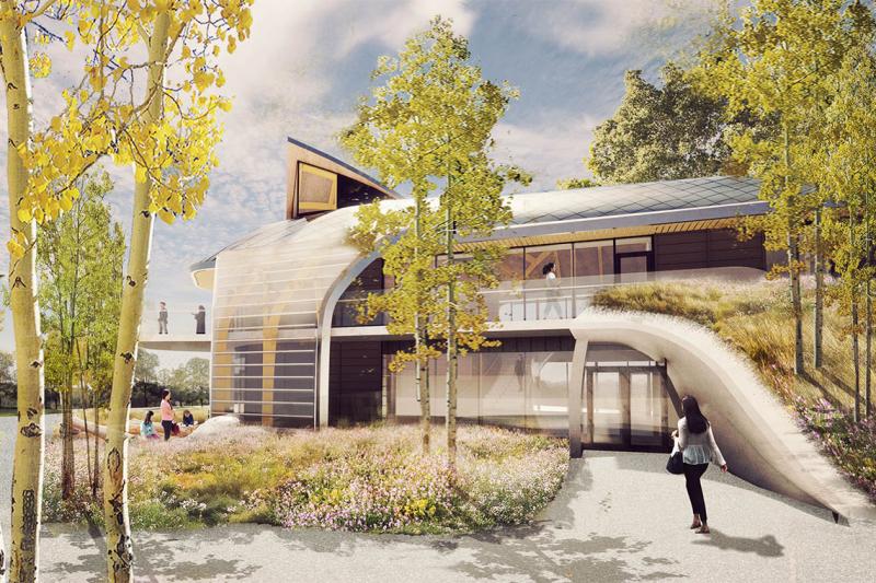An illustration of the planned Indigenous House shows curving shapes and a green roof.