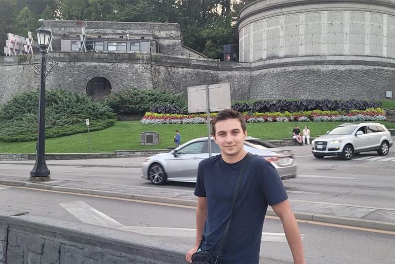 Rahul Kalvapalle posing outdoors in front of a road