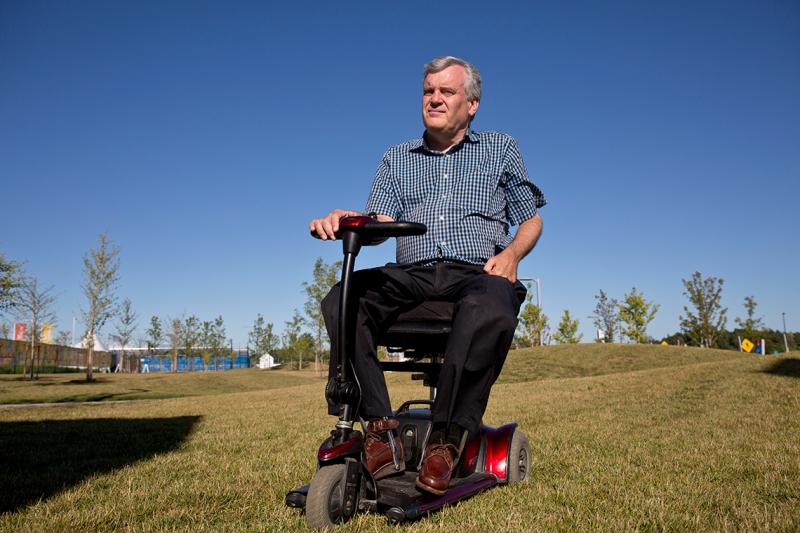 David Onley outside on a motorized wheelchair