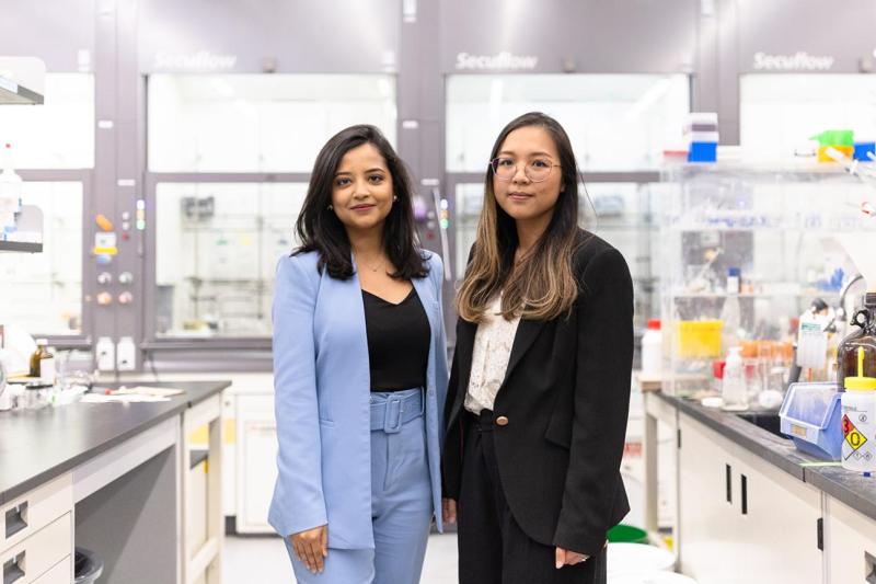 Two women standing in a lab