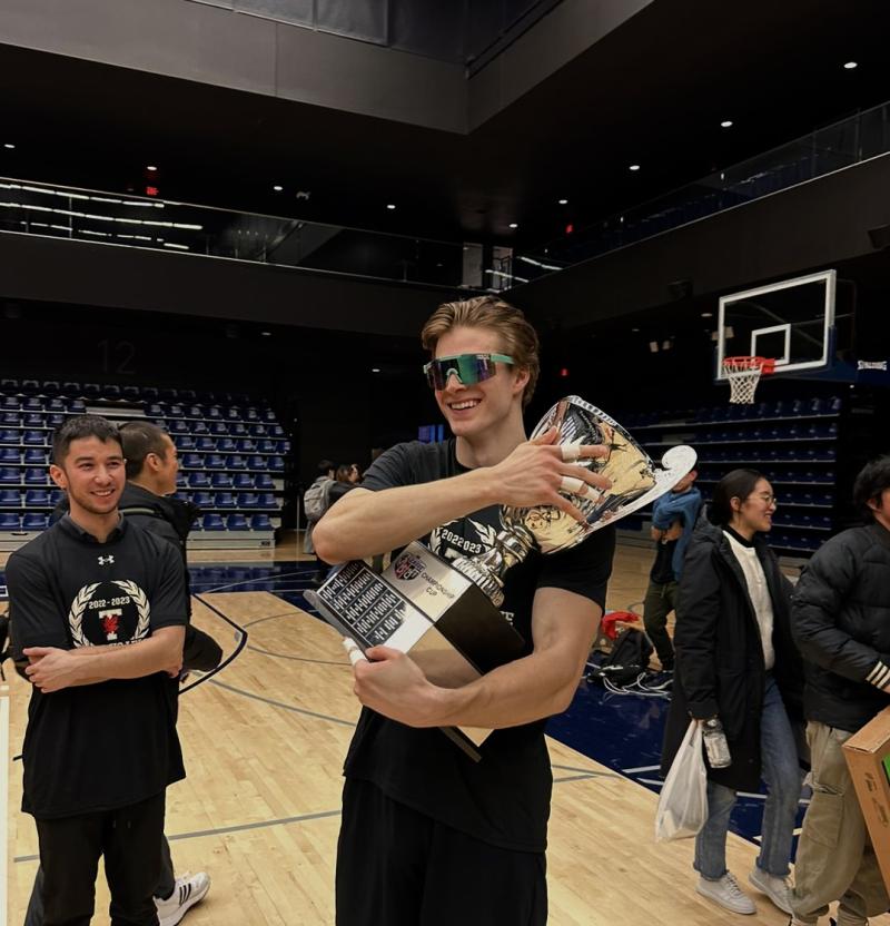 Matthew Kieffer holding a large sports trophy