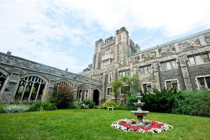 The Knox College quad is a roomy space of lush grass and a sundial, enclosed within an old stone building.