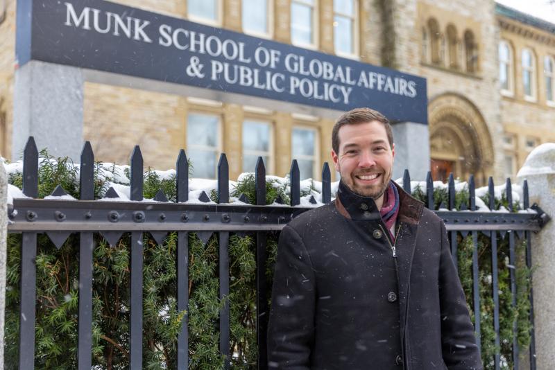 David Kepes standing in front of U of T's Munk School