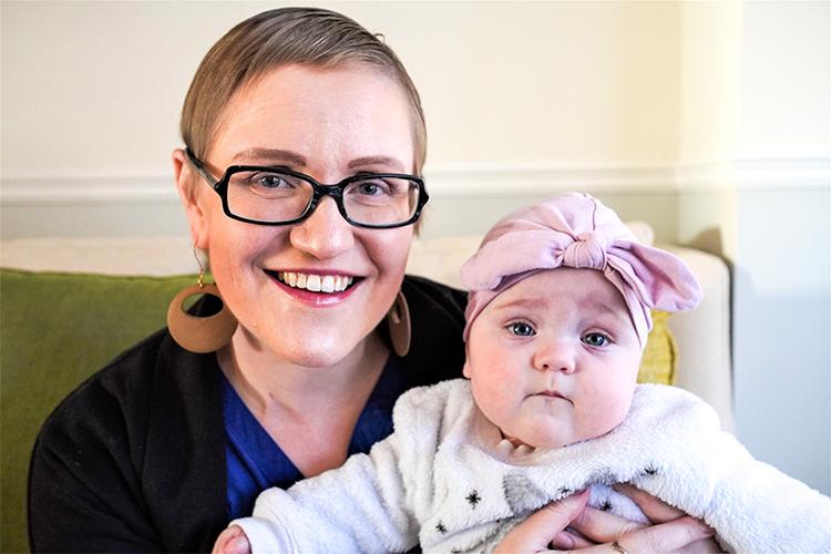 Margaret Loniewska smiles as she cuddles her baby daughter.