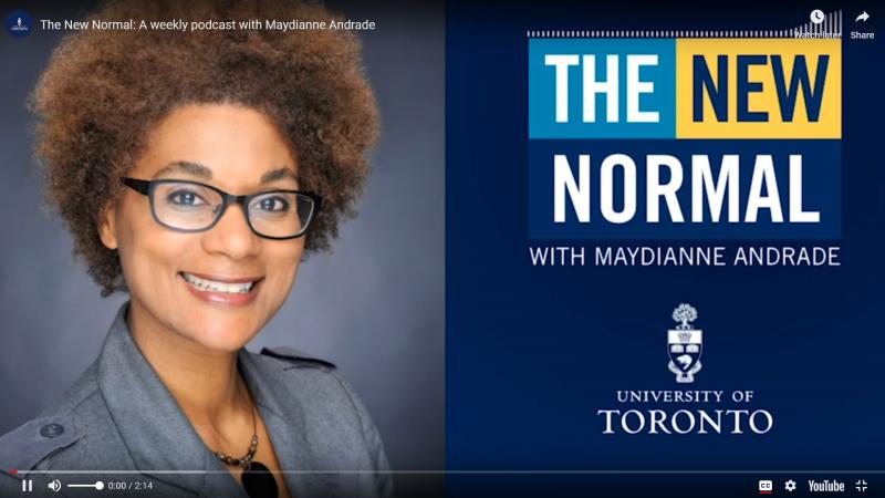 Maydianne Andrade smiles next to a screen showing the name of her podcast: The New Normal.