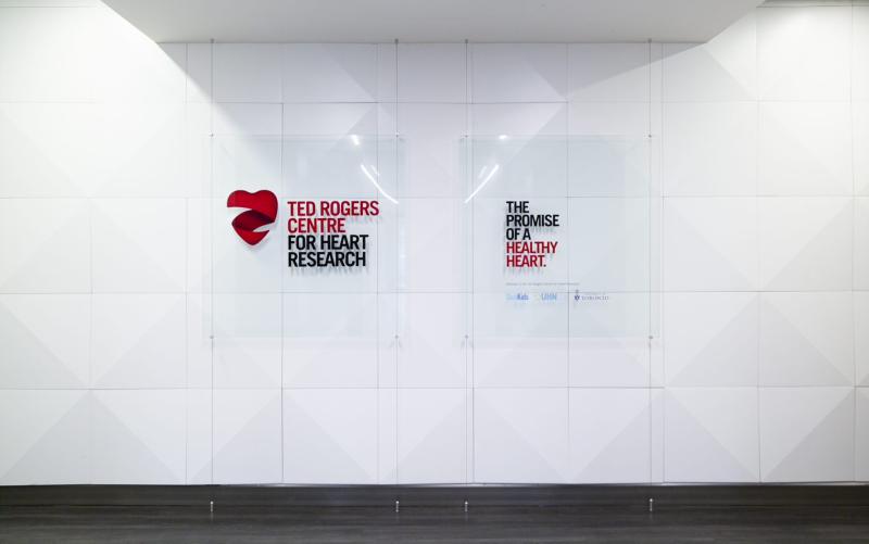 Signs on a wall: Ted Rogers Centre for Heart Research, the promise of a healthy heart.
