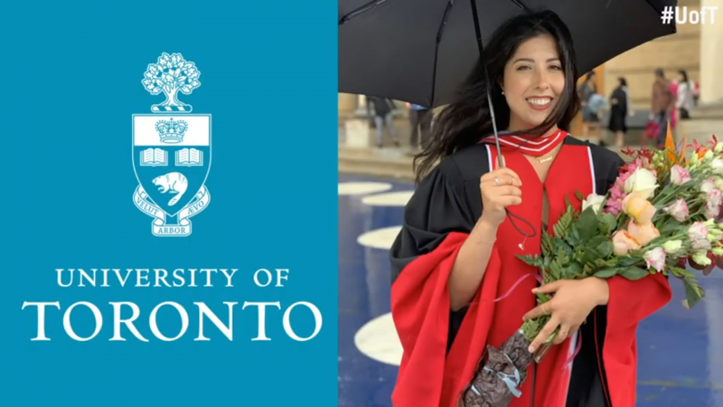 Samantha Yammine smiles, wearing academic robes and holding flowers and an umbrella.