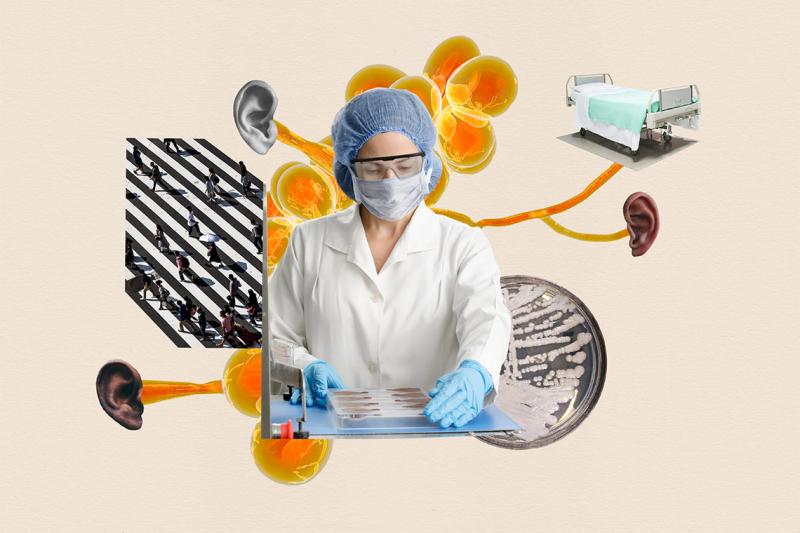 A woman in hairnet, glasses, mask, labcoat and gloves holds a tray of biological samples.