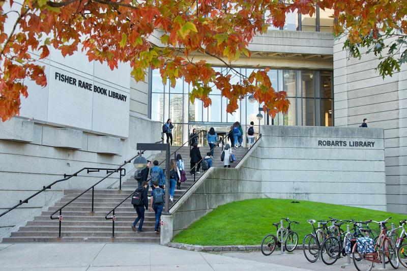 Several students climb the steps of Robarts Library.