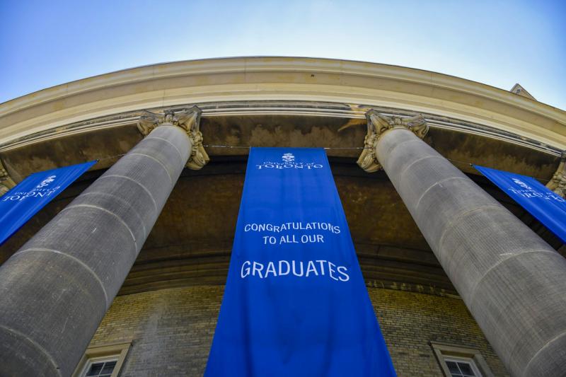 Banners hang between the pillars at Convocation Hall. They read: Congratulations to all our graduates