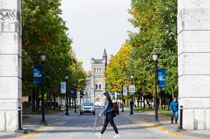 Students walk along King's College Road with University College in the background.