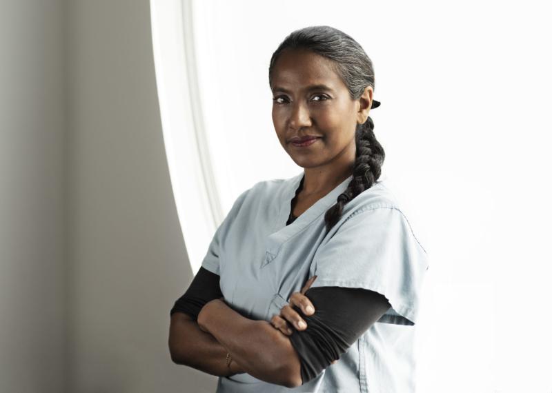 Suvendrini Lena stands with her arms crossed in front of her body