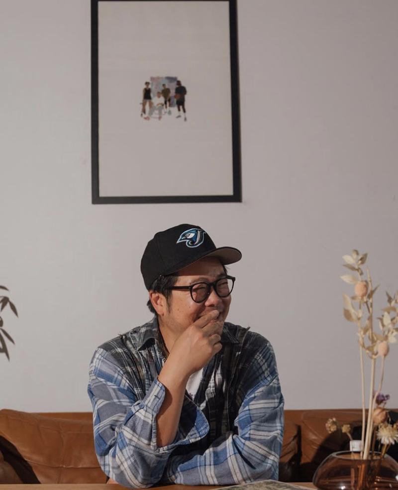 Alex Wong wearing a baseball cap