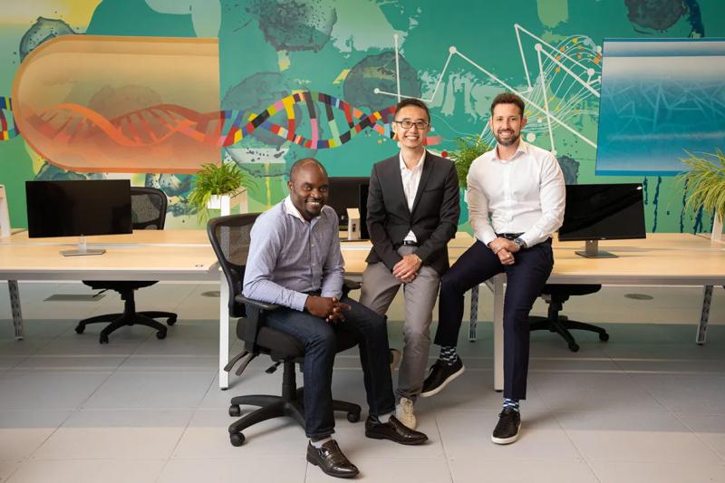 The three co-founders of BenchSci, Elvis Wianda, Tom Leung and Liran Belenzon, sitting in an office and smiling
