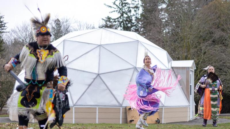Indigenous dancers performing in front of a white dome