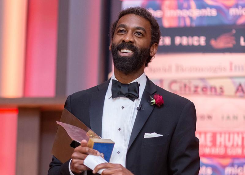 Photo of Kai James holding the 2019 Giller Prize