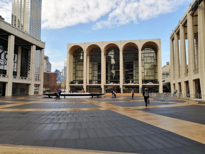 The Metropolitan Opera house in New York City has a front with five narrow, tall, rounded arches.