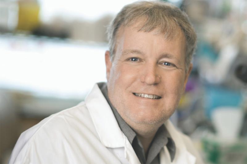 Portrait of Jeff Wrana smiling and wearing a lab coat.