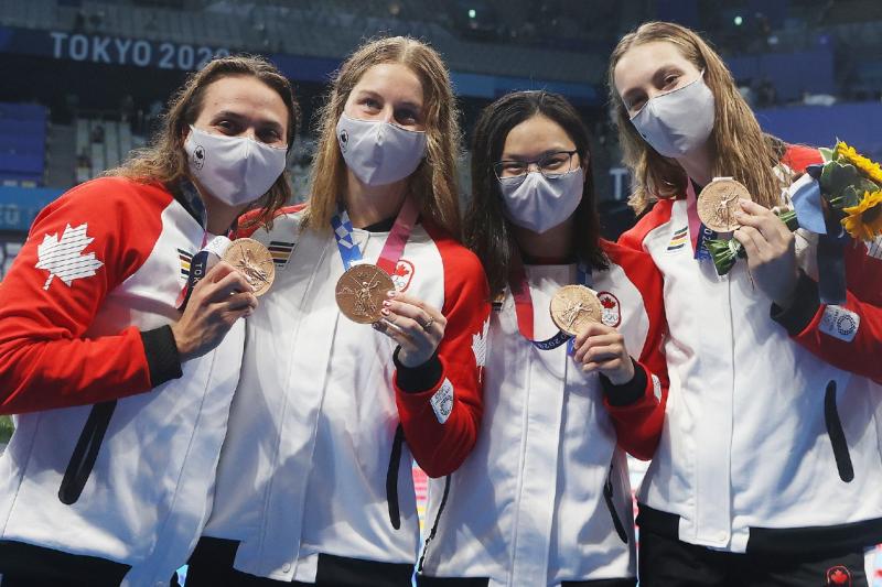 Kylie Masse, Sydney Pickrem, Maggie Mac Neil and Penny Oleksiak hold up their bronze medals for relay swimming.