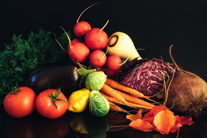 An array of vegetables: tomatoes, eggplant, carrots, summer squash, brussels sprouts, radishes, cabbage, beetroot, parsnip.