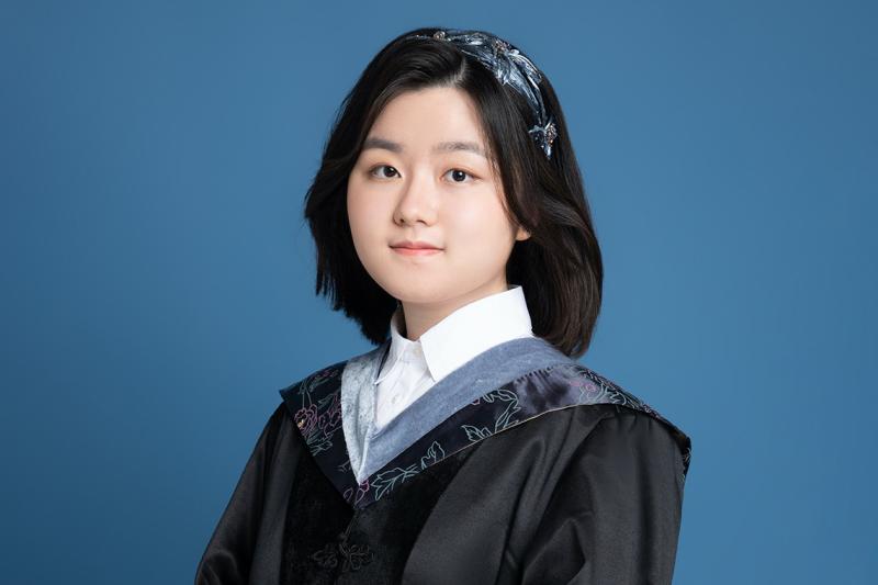A formal portrait of Vivian Xie in her graduation robes.