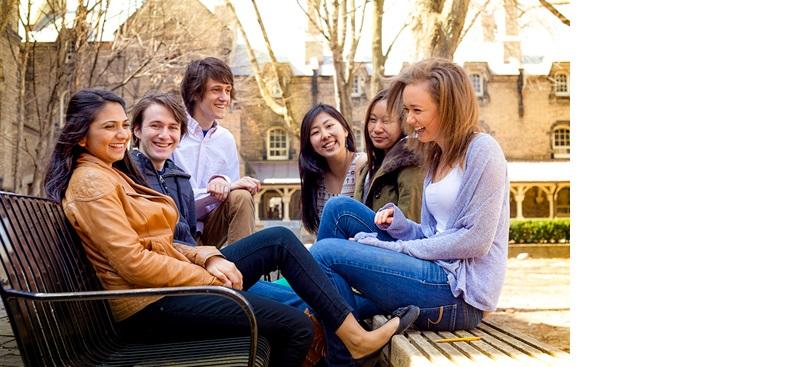 4 students sitting outside