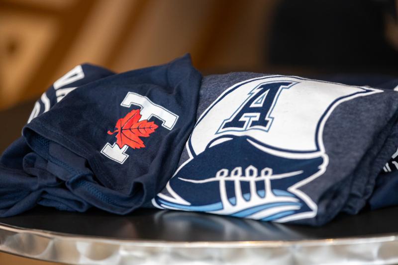 Varsity Blues shirt beside a Toronto Argonauts shirt
