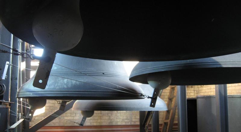 Sunlight glinting on large bells