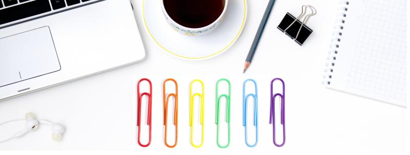 Rainbow paperclips arranged on a desk