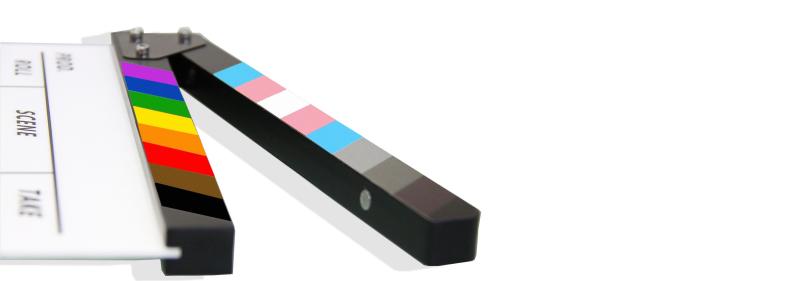 movie clapper with LGBTQ+ flag and trans flag rainbow