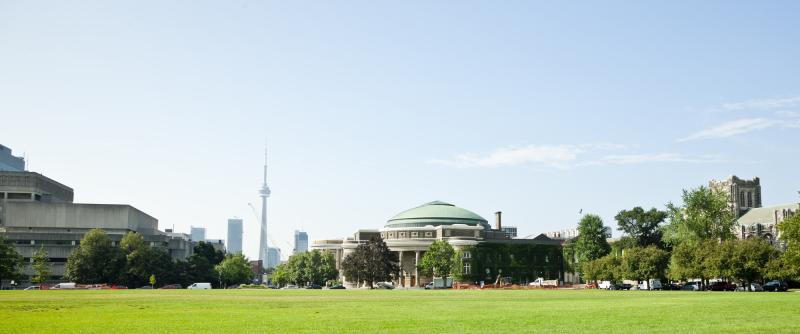 Panoroma photo of Front Campus and Convocation Hall in summer, with CN Tower in the background.